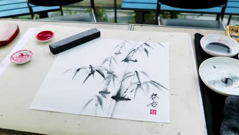 a nihonga, a traditional japanese painting, with a hanko, a red signature stamp