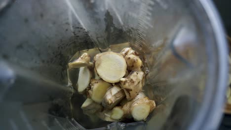 Nice-shot-of-fresh-cut-ginger-inside-of-a-blender-ready-to-be-blended-into-a-beverage