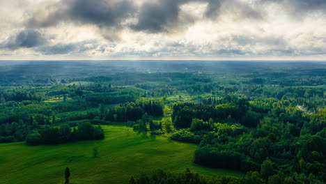 aerial hyperlapse of dramatic rolling clouds moving over forest and fields