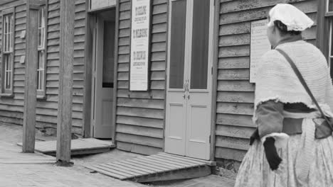 an old lady walks through a historical town