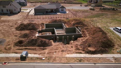 a drone shot spinning around a foundation and basement walls that had just been poured