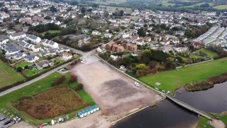 Aerial-Over-River-Char-With-View-Of-Empty-Car-Park-In-Charmouth-Village-In-Dorset