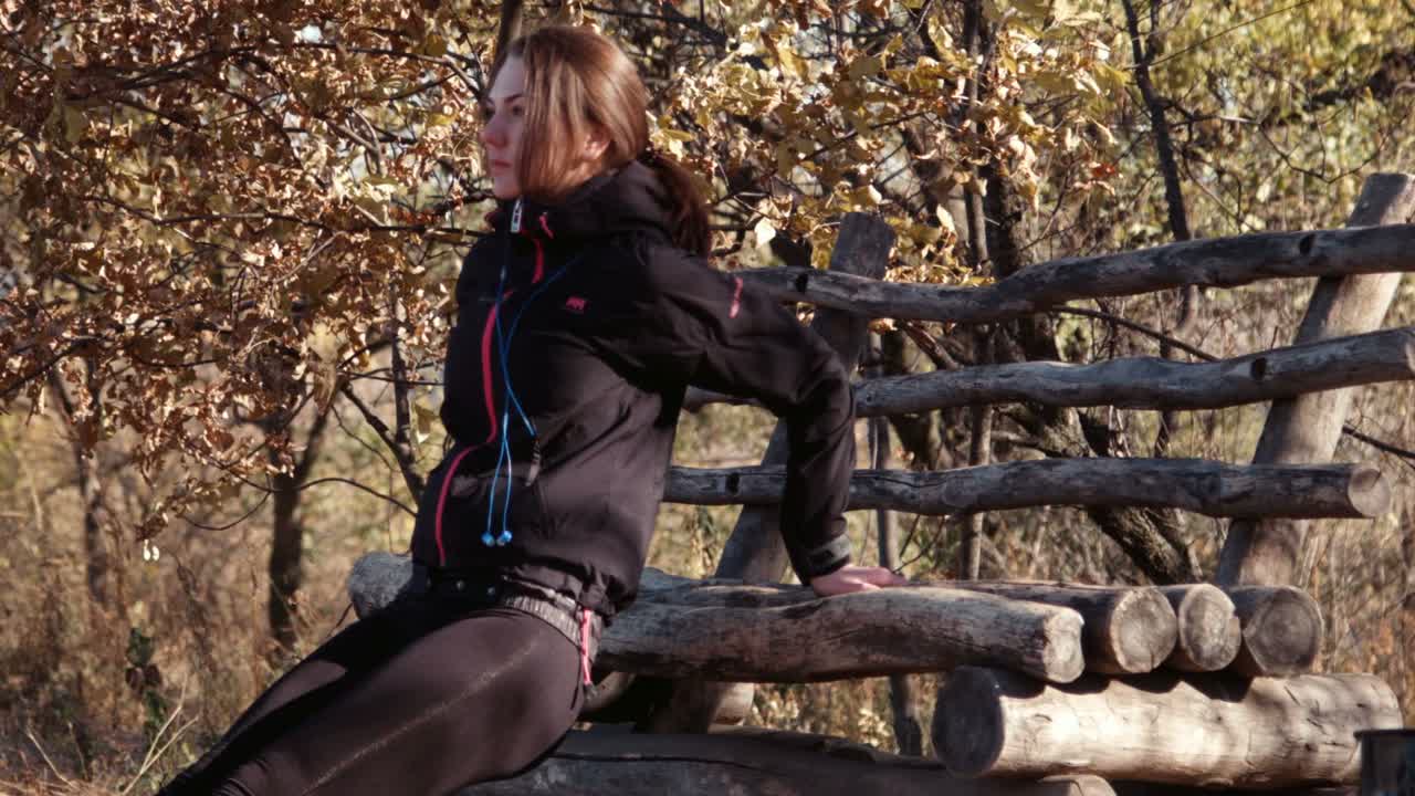 The Girl Does Exercises In Autumn Park