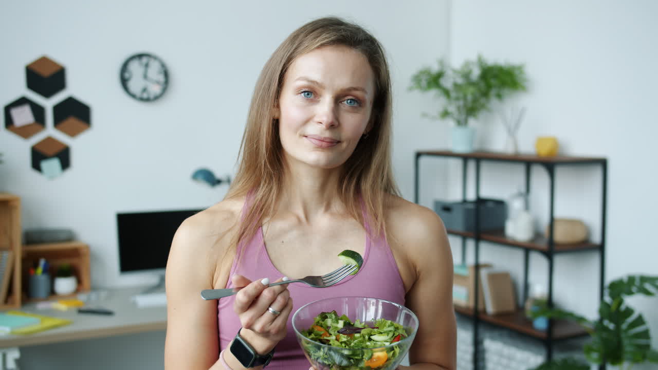 Woman Eating Healthy Salad in Home Office