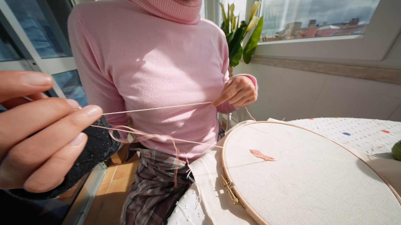 Close-up of Woman's Hands Embroidering with a Wrist Brace