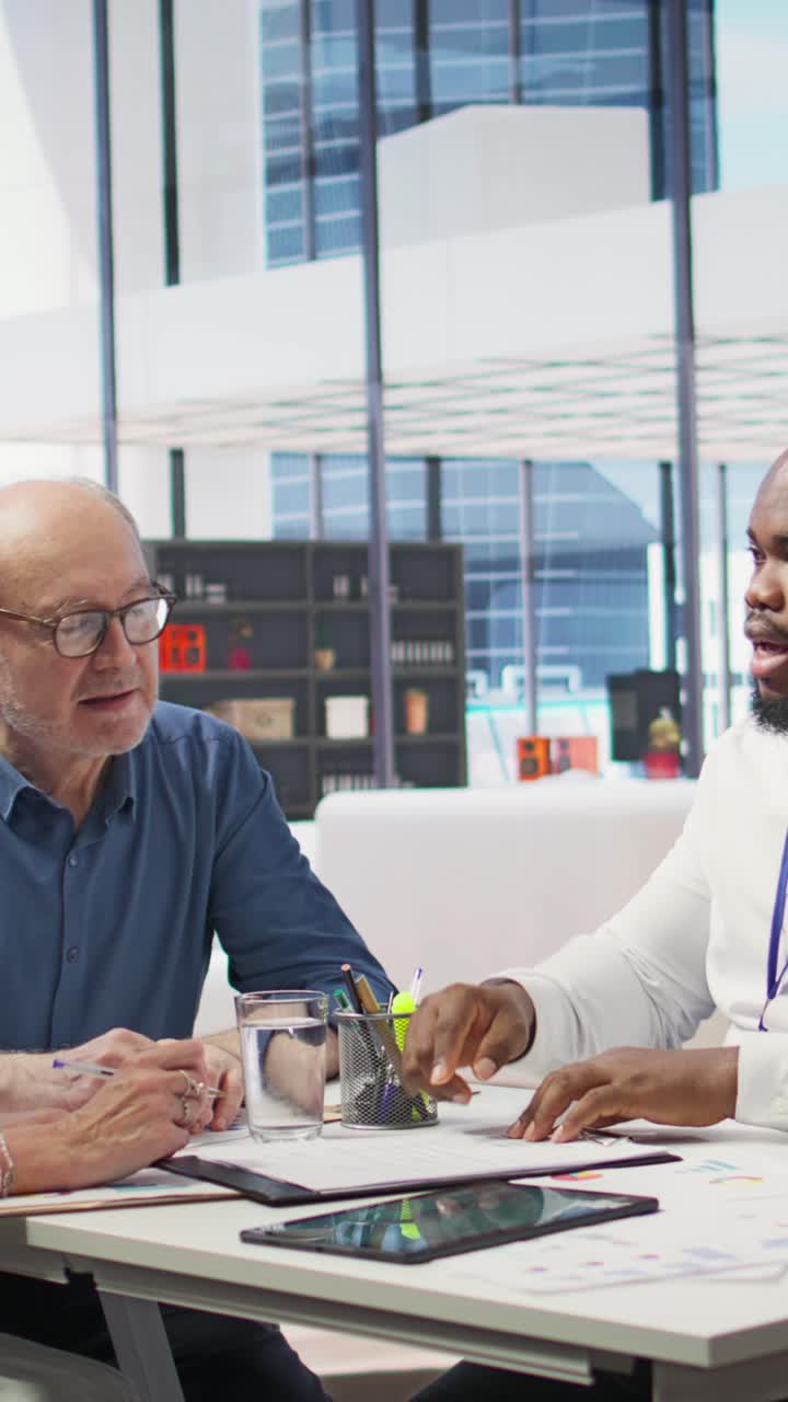 Vertical Video Senior citizens consulting a financial planner about retirement planning