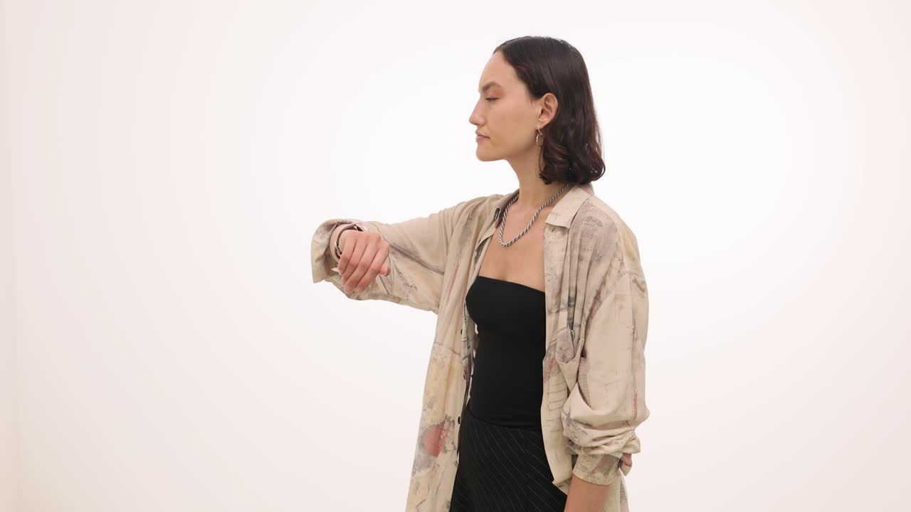 Young Woman Making Hand Gestures and Looking to the Side in a Studio