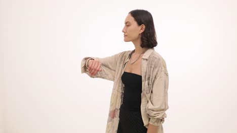 young woman making hand gestures and looking to the side in a studio