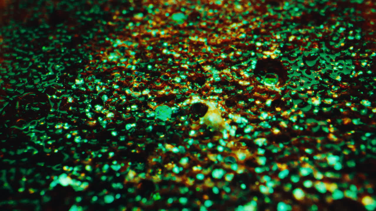 Close-up view of a textured surface with glitter and vibrant colors
