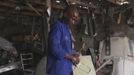 african man painting a car