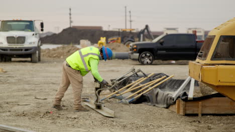 construction worker cleaning machinery head