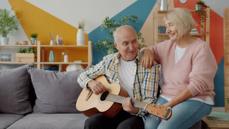 senior couple enjoying music together at home