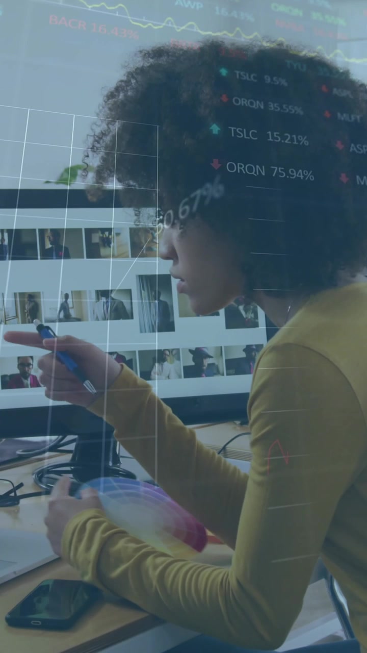 A woman is working in a creative office and using a laptop