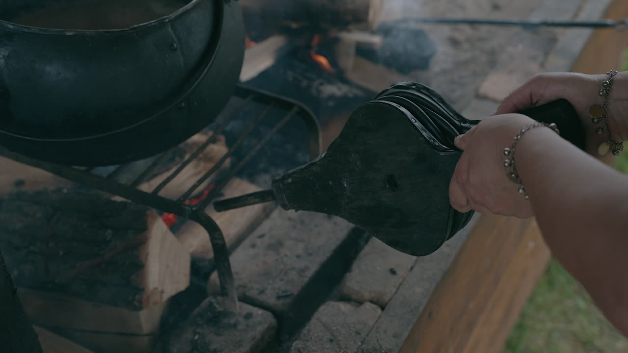 Cooking over a campfire using traditional methods