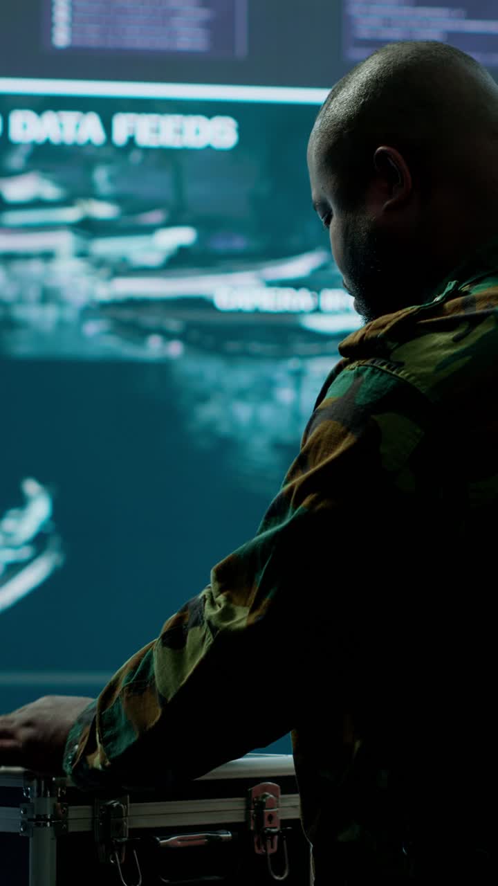Vertical Video Army espionage specialist in a control center collecting satellite cctv data