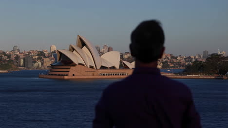 Person views the iconic Sydney Opera House across the water