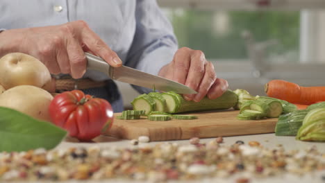 woman preparing vegetables in modern home kitchen, cooking meal on table, cutting zucchini