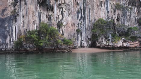 calm water gently laps against a rugged cliff