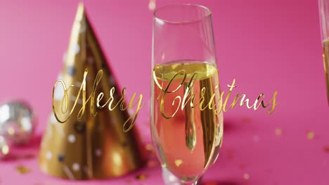 Animation-of-christmas-greetings-text-over-christmas-party-hat-and-glass-with-champagne
