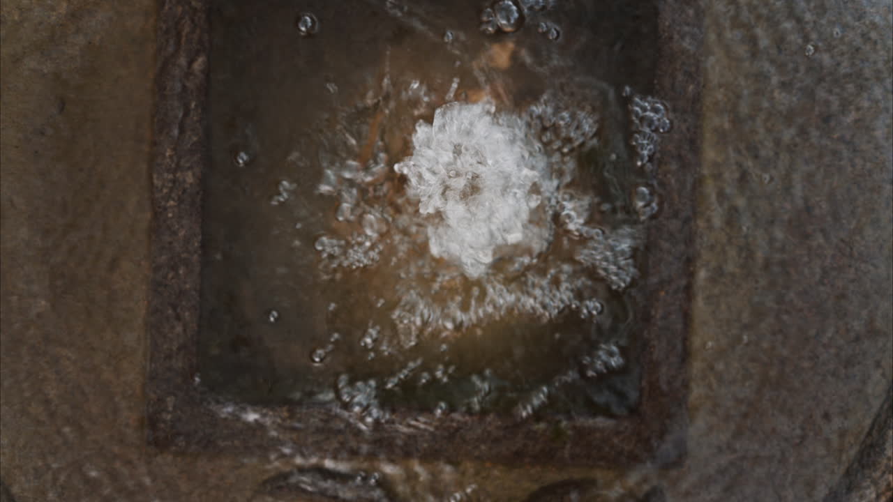Small water fountain in the Princess Grace Japanese Garden City park in Monaco
