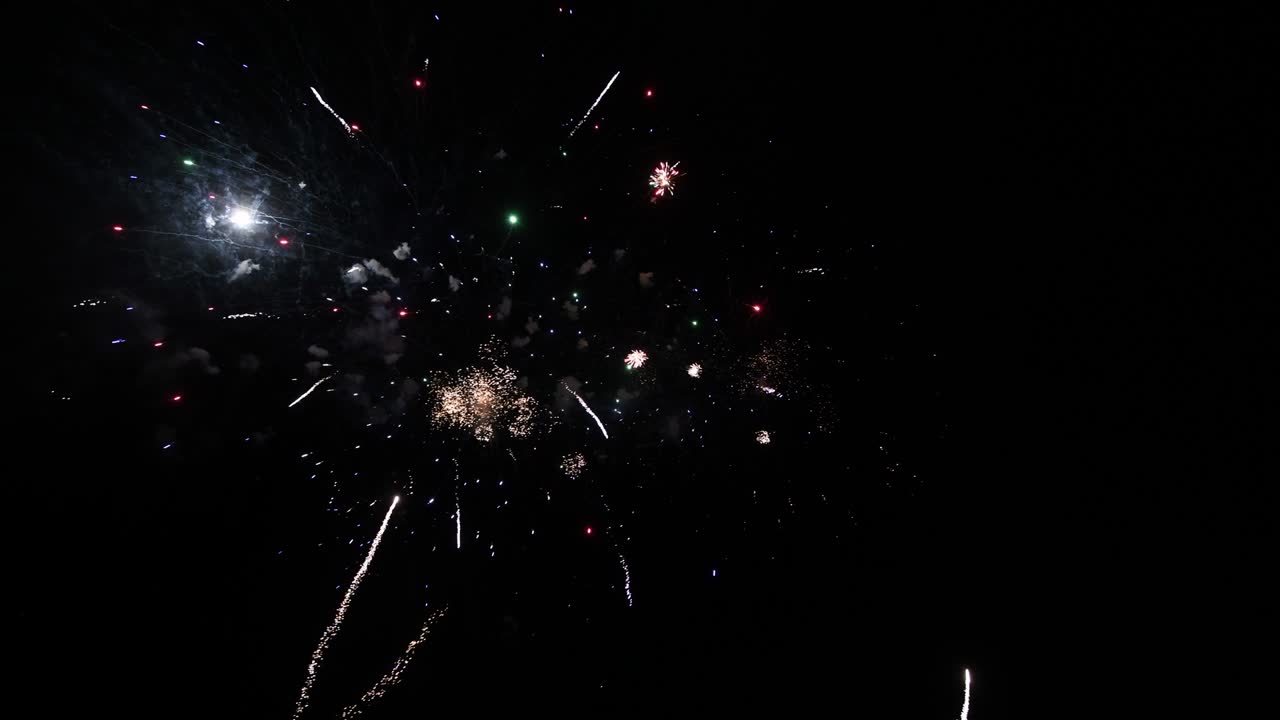 largo tiempo bucle sin fisuras de verdadero abstracto colorido espectáculo de fuegos artificiales festival en el cielo de fondo negro durante el día festivo nacional, fiesta de año nuevo 2022