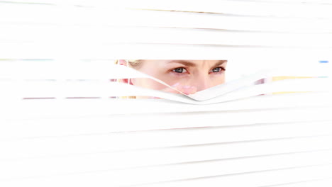 curious woman looking through blinds