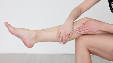 woman applying moisturizing lotion to her leg