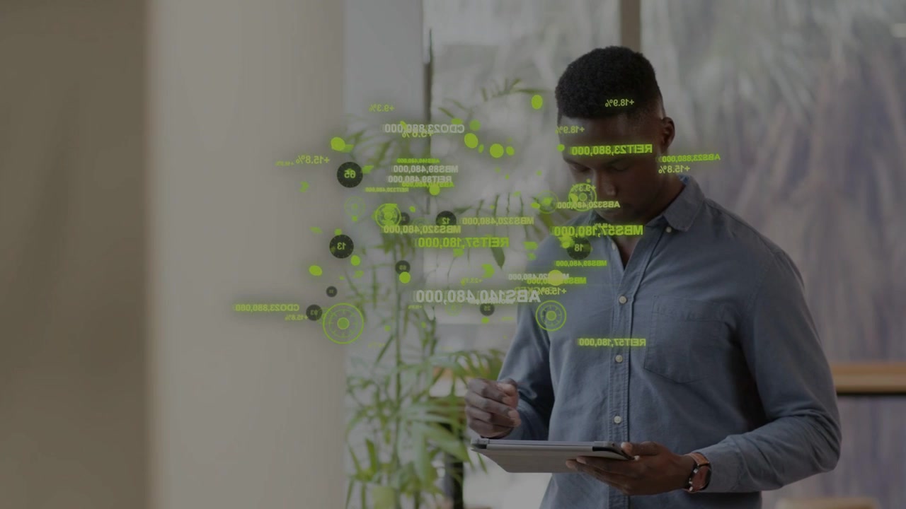 Man tapping tablet by glass, starting green HUD growing and shifting while reading business metrics