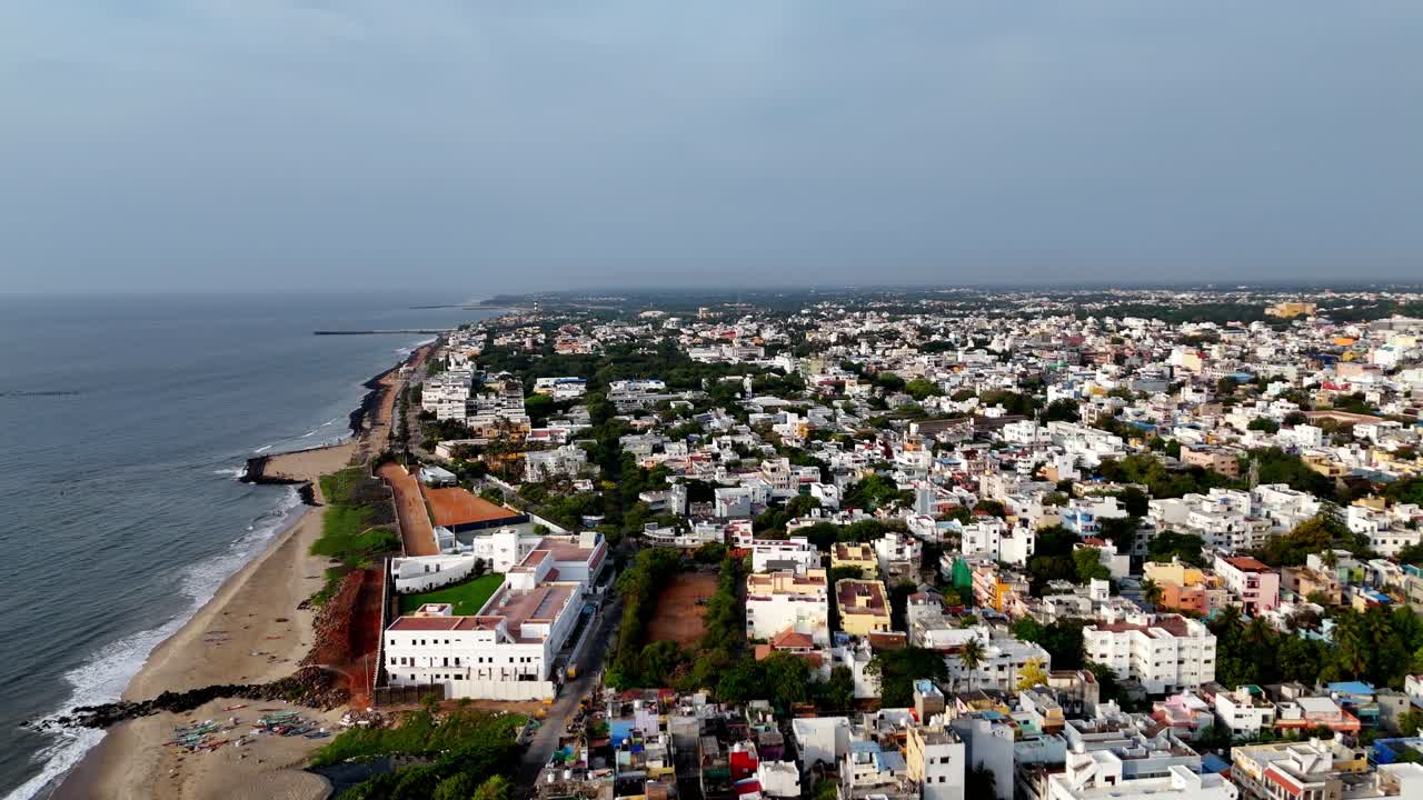 Expansive aerial view of the Puducherry coastline. This footage showcases the city's unique charm, from its buildings to the Bay of Bengal's tranquil waters