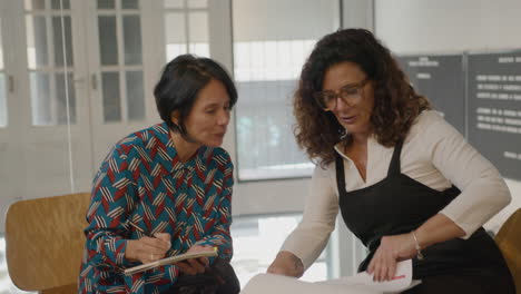mature business ladies having meeting in coworking room