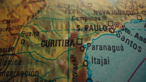 close-up of a world globe map focusing on curitiba, brazil
