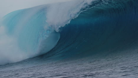 Majestic-powerful-ocean-wave-barreling-and-crashing-into-whitewash-with-view-down-barrel,-Cloudbreak-Fiji,-slow-motion