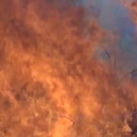 fire trucks and vehicles burn during a large wildfire