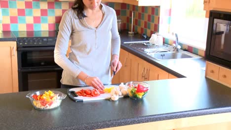 Smiling-woman-preparing-salad