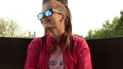 Girl-with-red-jacket-sitting-in-the-park