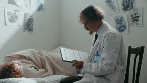 psychiatrist examining patient with flashlight and taking notes in ward