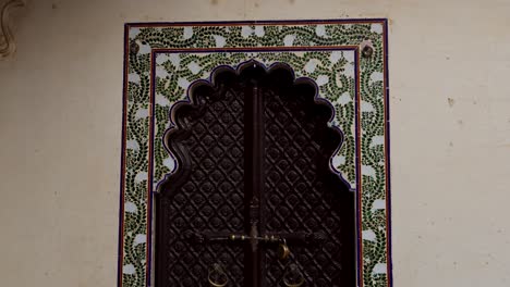 ornate carved wooden door with intricate tile work