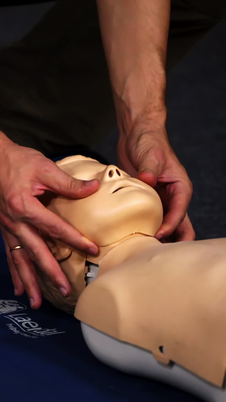 Experienced doctor shows methods of health treatment on medical dummy. Selective focus from the side. Vertical video