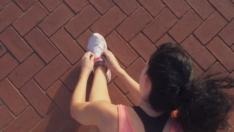 Runner-woman-tieing-shoelace-outdoors-exercise