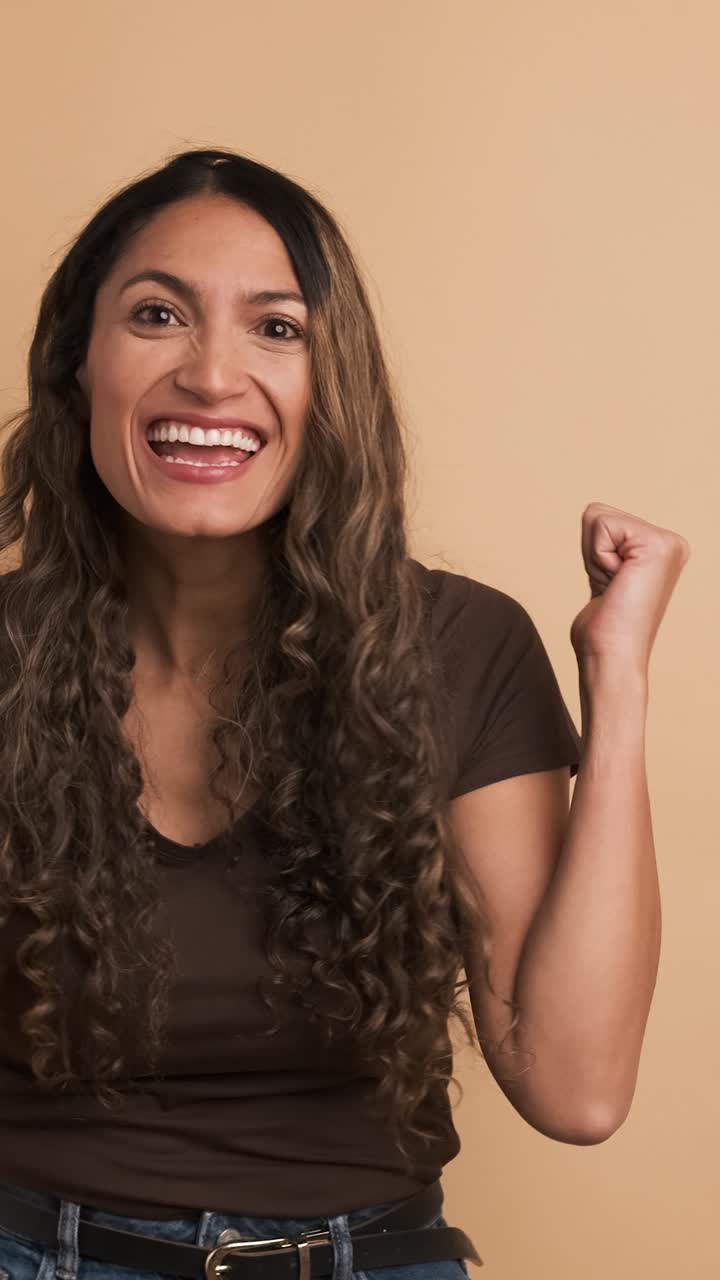 Hispanic woman gesturing agreement with thumb up. Vertical Footage
