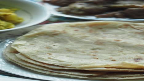 stack of roti with other dishes