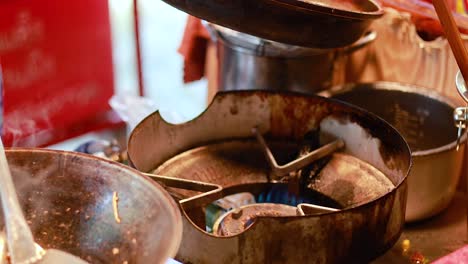 chef prepares pad thai at bangkok's floating market