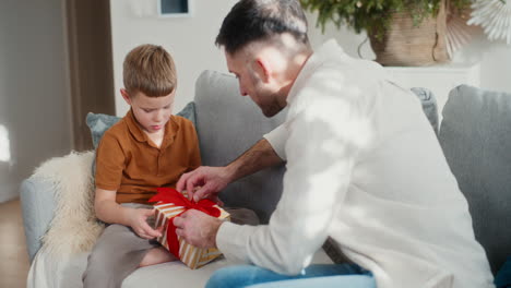 dad and son prepare christmas presents and gifts for the holidays