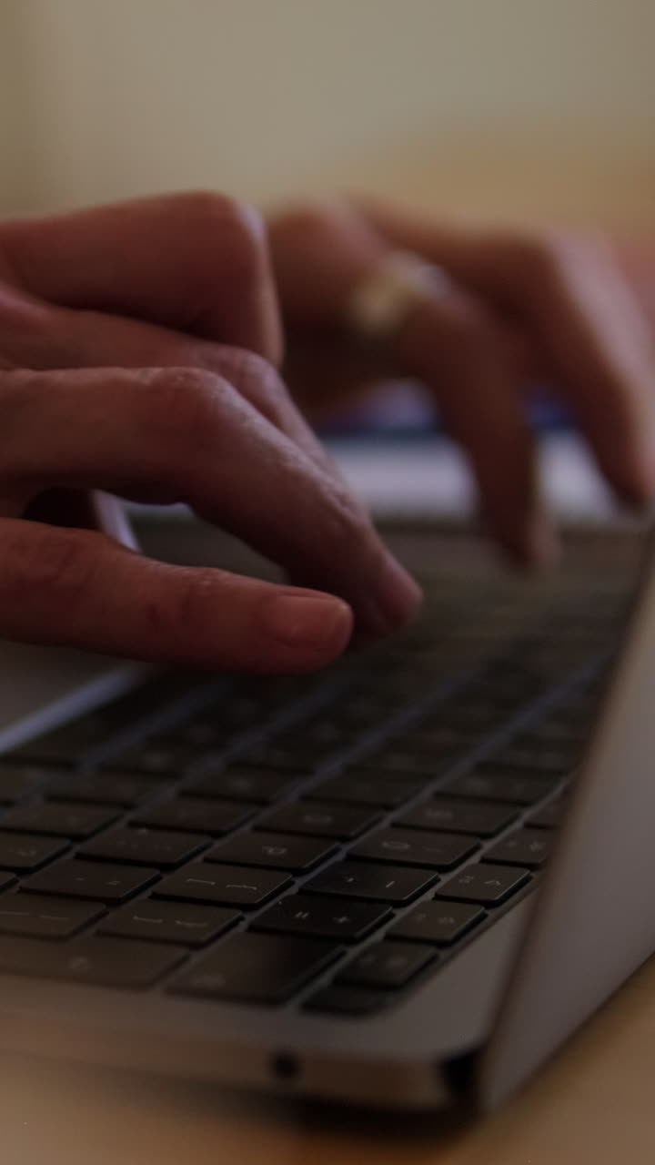 Close Up of Hands Typing on Laptop Keyboard