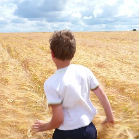 boy running through a wheat field