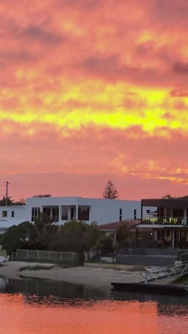 vibrant sunset reflecting on tranquil canal waters