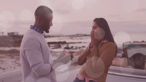 Animation-of-happy-african-american-man-proposing-to-his-biracial-girlfriend-at-cabriolet