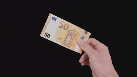 male hand shows a banknote of 50 euros with alpha channel