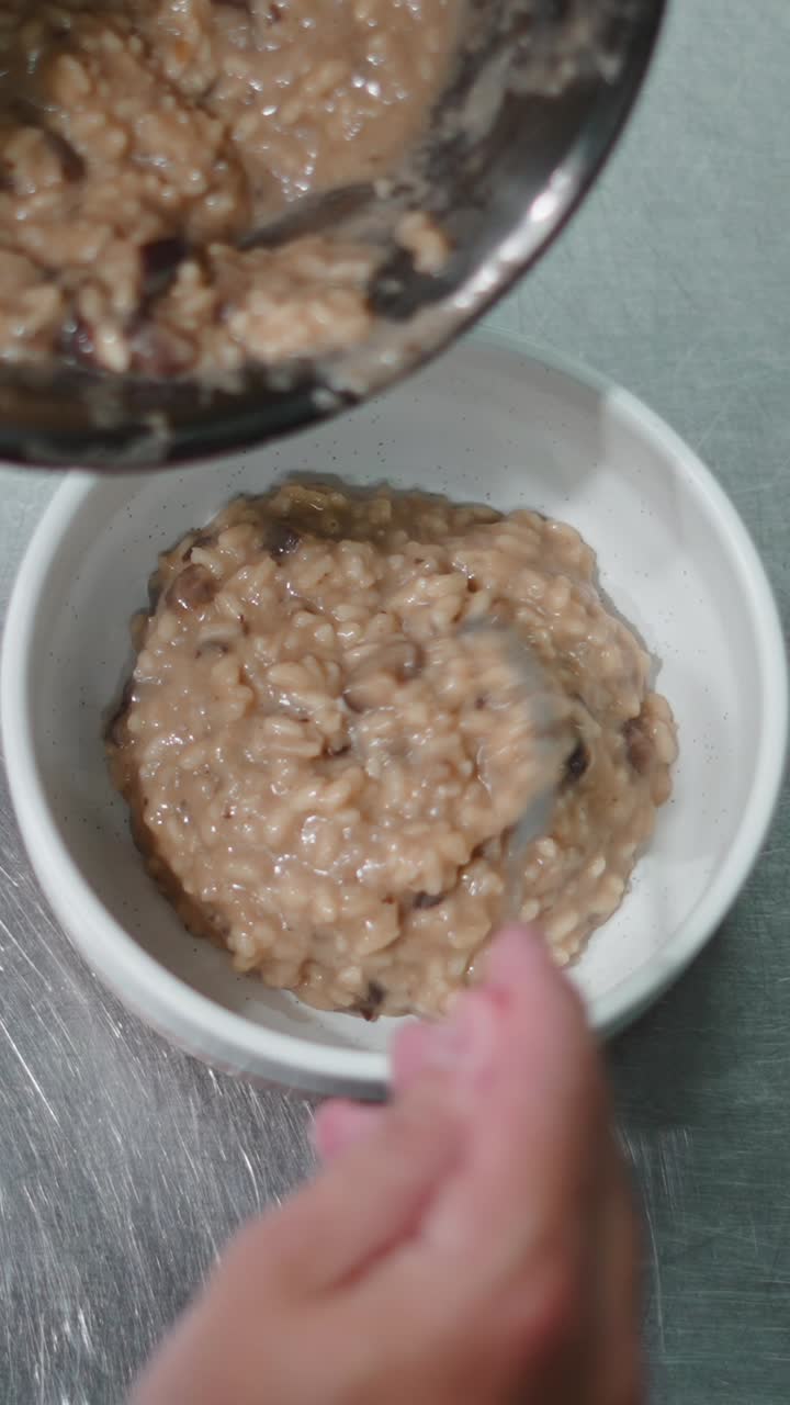 Mushroom risotto being served in a bowl
