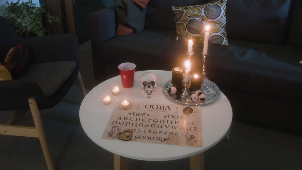 Spooky Halloween Scene with Ouija Board and Candles